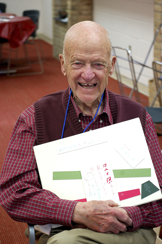 A PARTICIPANT WHO LEARNED JAPANESE IN WORLD WAR II INCLUDES JAPANESE CHARACTERS IN HIS COLLAGE.
